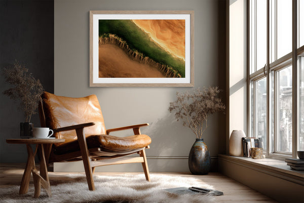 A framed landscape art print featuring a green and orange canyon scene