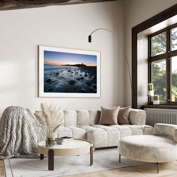 Ethereal Dawn coastal wall art featuring Northumbrian castle ruins, rocky shoreline and calm sea at sunrise