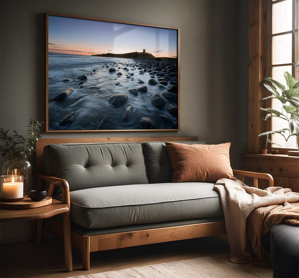 Ethereal Dawn coastal wall art featuring Northumbrian castle ruins, rocky shoreline and calm sea at sunrise