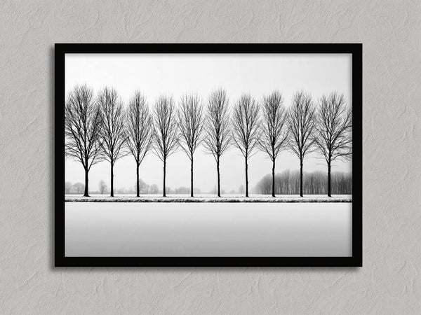 Black and white tree wall art featuring a row of bare winter trees across a minimalist snowy landscape