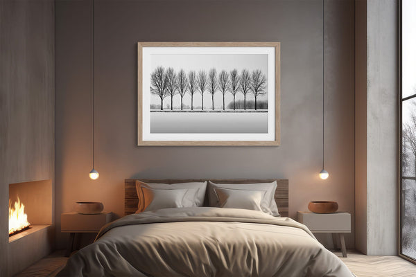 Black and white tree wall art featuring a row of bare winter trees across a minimalist snowy landscape