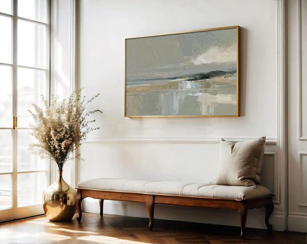 Framed Pale Estuary artwork above a wooden bench, with a vase of dried branches by tall windows.