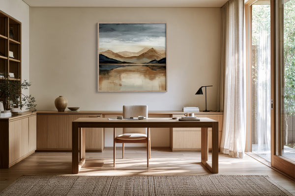 Mountain lake artwork above a wood desk with chair, shelving, and floor-to-ceiling windows.
