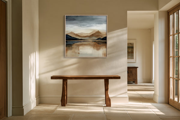 Framed mountain lake artwork above a rustic wood bench in a sunlit hallway.