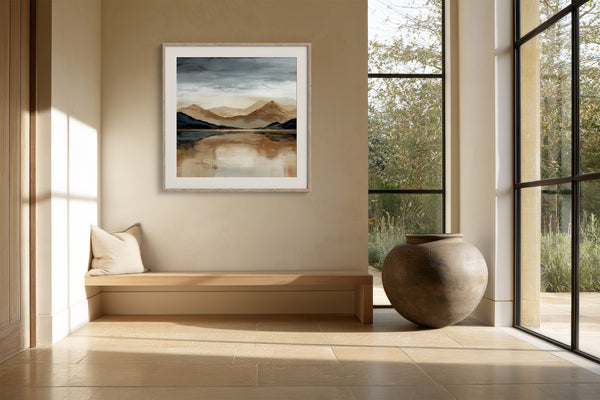White-framed mountain lake artwork above a built-in bench beside tall black-grid windows.