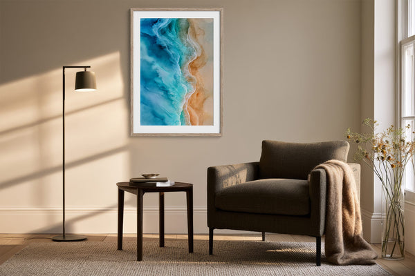 White-framed shoreline artwork above a dark armchair, side table, and floor lamp.