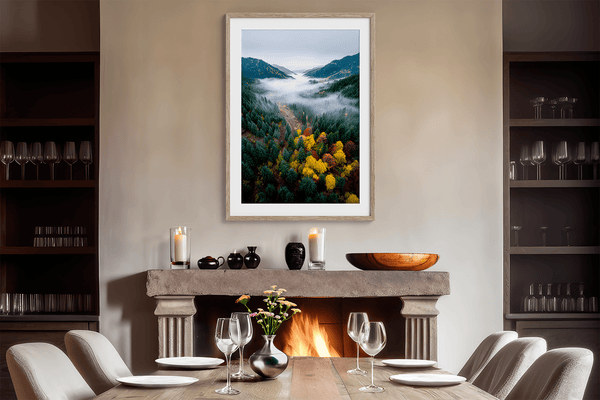 Framed fine art print of a misty valley in fall colours. Red, gold, and evergreen forest hues captured in a vivid autumn woodland scene.