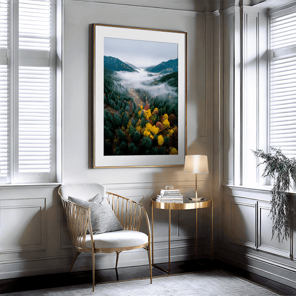 Framed fine art print of a misty valley in fall colours. Red, gold, and evergreen forest hues captured in a vivid autumn woodland scene.