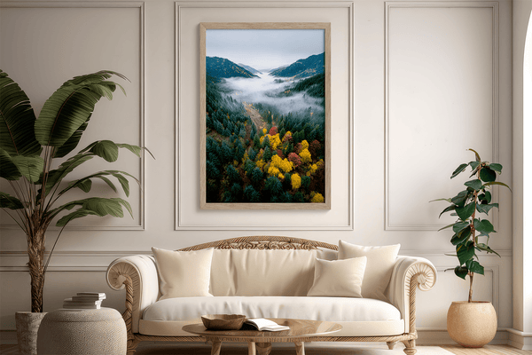Framed fine art print of a misty valley in fall colours. Red, gold, and evergreen forest hues captured in a vivid autumn woodland scene.