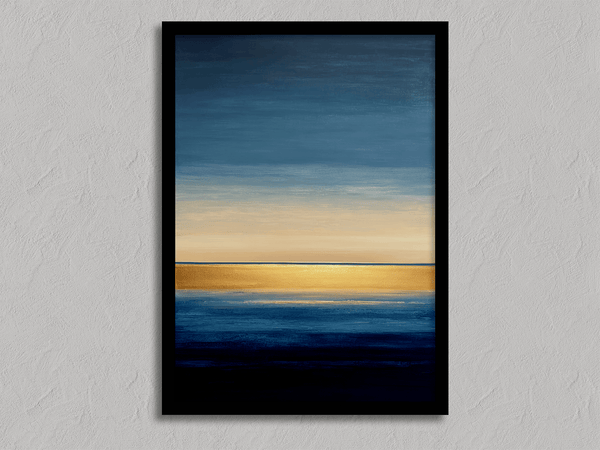 Framed wall art of an abstract seascape in deep indigo, blue, and gold. A minimalist horizon print evoking calm and renewal.