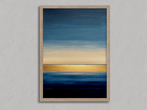 Framed wall art of an abstract seascape in deep indigo, blue, and gold. A minimalist horizon print evoking calm and renewal.