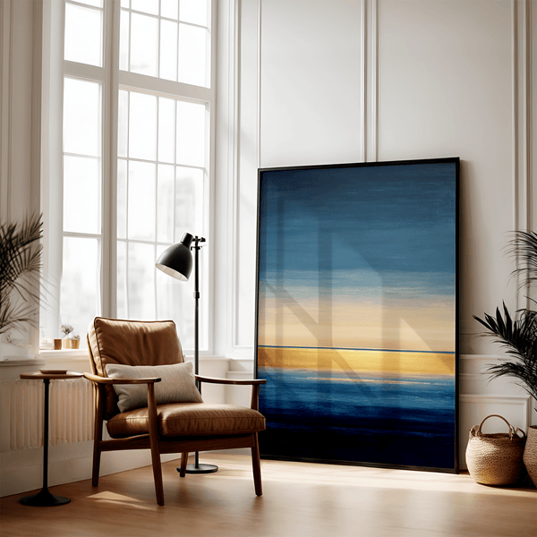 Framed wall art of an abstract seascape in deep indigo, blue, and gold. A minimalist horizon print evoking calm and renewal.