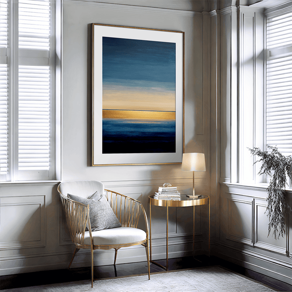 Framed wall art of an abstract seascape in deep indigo, blue, and gold. A minimalist horizon print evoking calm and renewal.