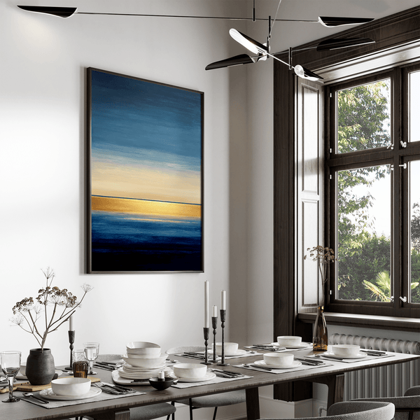 Framed wall art of an abstract seascape in deep indigo, blue, and gold. A minimalist horizon print evoking calm and renewal.