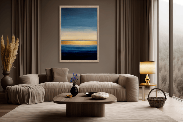 Framed wall art of an abstract seascape in deep indigo, blue, and gold. A minimalist horizon print evoking calm and renewal.