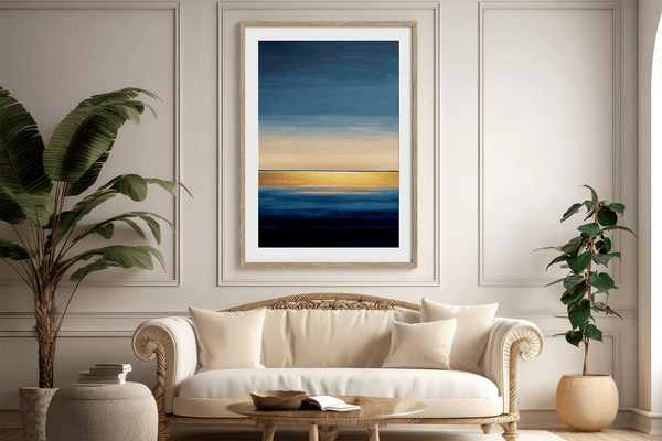 Framed wall art of an abstract seascape in deep indigo, blue, and gold. A minimalist horizon print evoking calm and renewal.