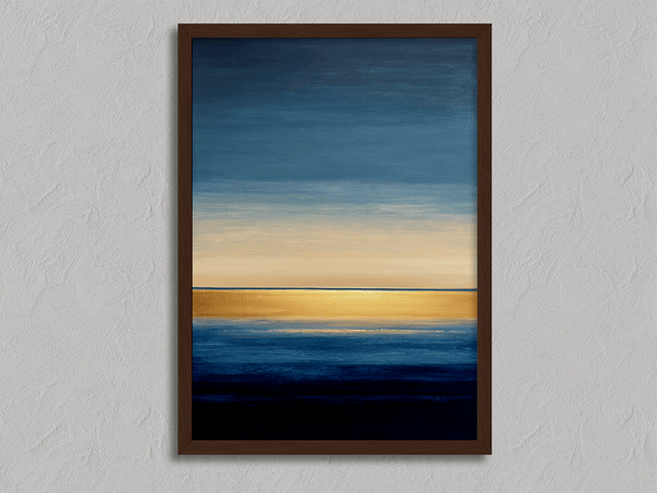Framed wall art of an abstract seascape in deep indigo, blue, and gold. A minimalist horizon print evoking calm and renewal.
