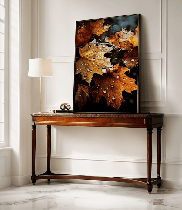 Framed wall art of crimson, amber, and sienna maple leaves with glistening droplets. A radiant autumn foliage print. Ready to hang.