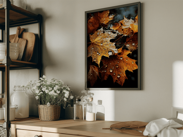 Framed wall art of crimson, amber, and sienna maple leaves with glistening droplets. A radiant autumn foliage print. Ready to hang.