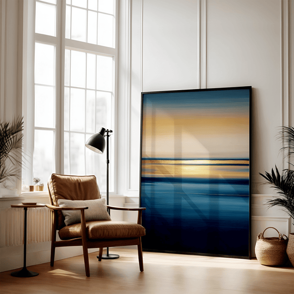 Framed wall art of an ocean sunset in coral, peach, and blue tones. A timeless abstract seascape print. Ready to hang.