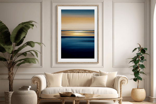 Framed wall art of an ocean sunset in coral, peach, and blue tones. A timeless abstract seascape print. Ready to hang.