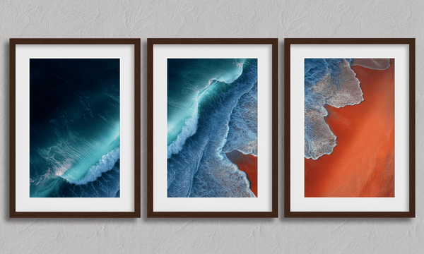 Coastal triptych framed wall art of teal waves and sienna sands. Framed or unframed ocean prints for serene, modern interiors.