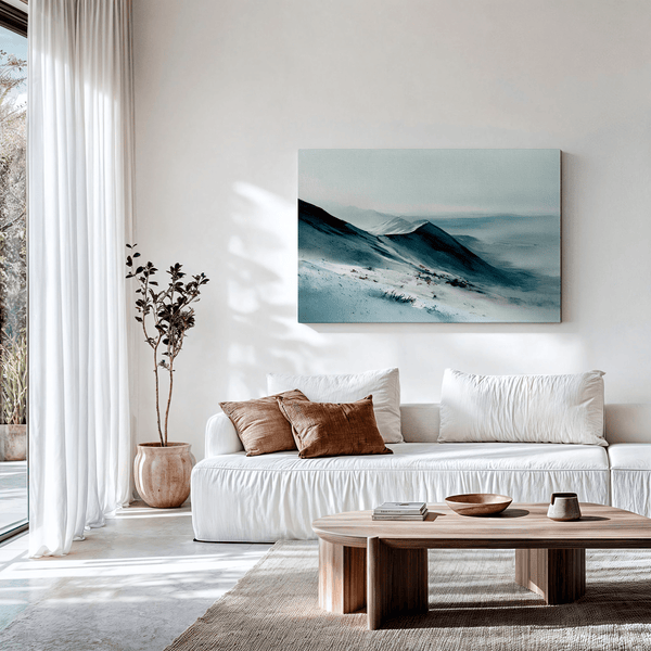 Framed canvas wall art of snowy peaks in soft watercolour blues and greys. A calm, minimalist mountain print. Ready to hang.