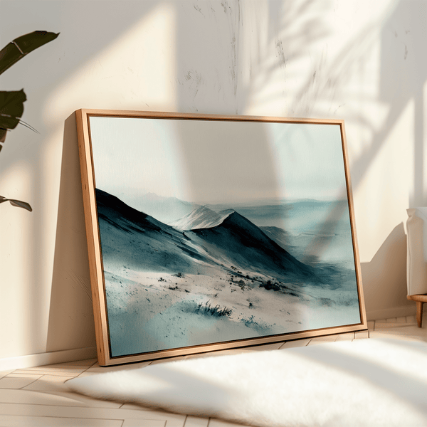 Framed canvas wall art of snowy peaks in soft watercolour blues and greys. A calm, minimalist mountain print. Ready to hang.