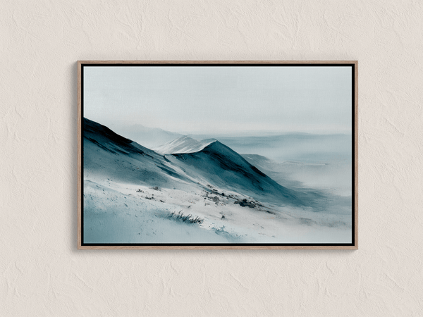 Framed canvas wall art of snowy peaks in soft watercolour blues and greys. A calm, minimalist mountain print. Ready to hang.