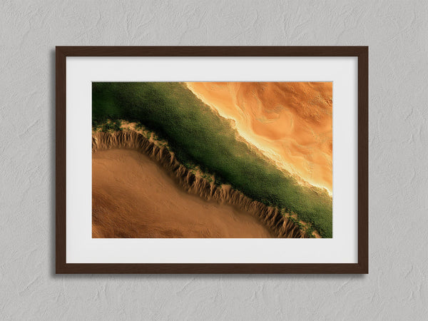 Edge of the Oasis shown in a walnut frame with a white border or mount.