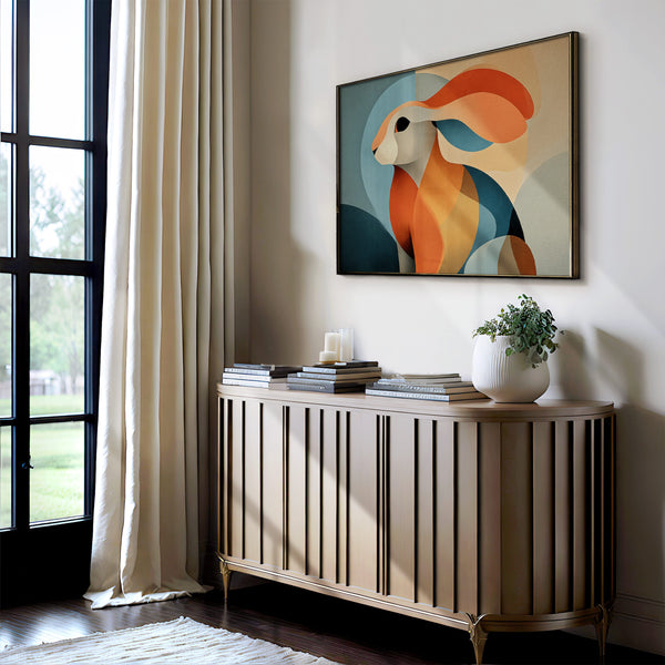 Thin dark-framed abstract hare print above a slatted console with books and a potted plant.
