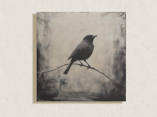 Canvas wall art of a solitary blackbird on a wintry branch. A peaceful monochrome bird print, ready to hang.