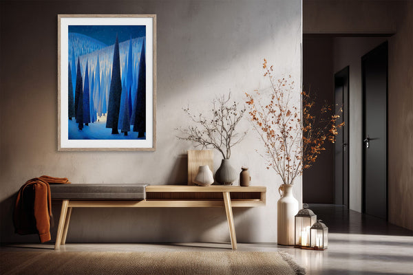 White-framed blue conifer forest artwork above a narrow wooden console in a hallway.