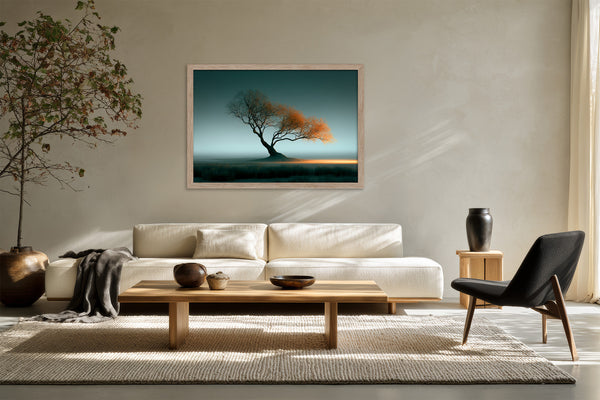 Leaning Light tree artwork in a pale wood frame above a white sofa and low coffee table.