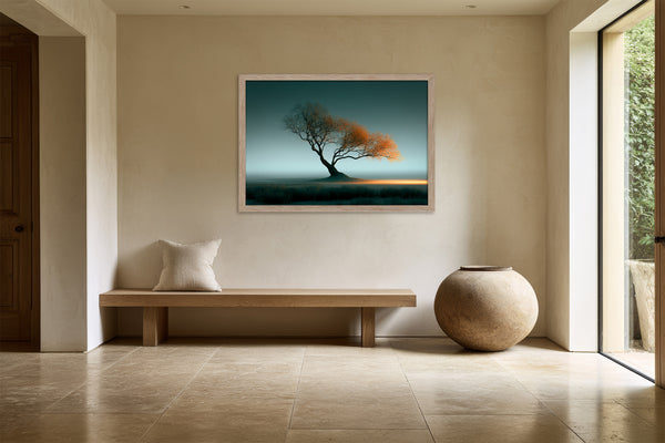Leaning Light tree artwork in a pale wood frame above a wooden bench beside a large ceramic vessel.
