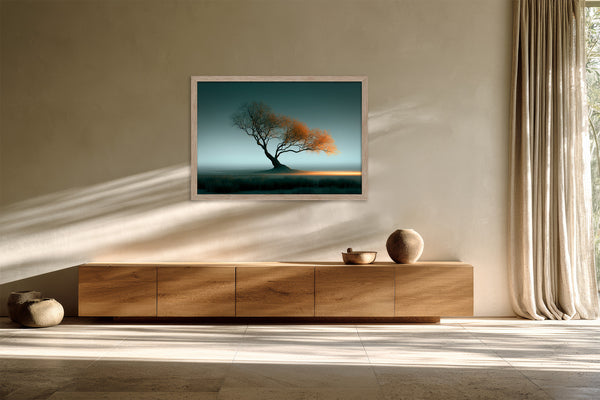 Framed Leaning Light tree artwork above a low wooden sideboard with ceramic objects.