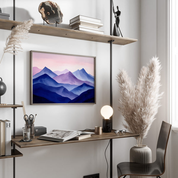 Violet Ranges mountain artwork in a dark frame displayed above a desk with shelves.