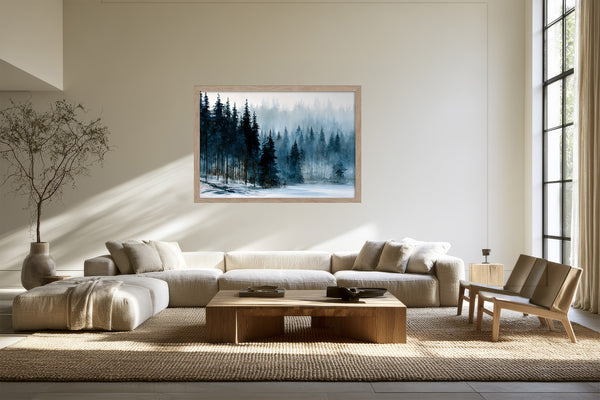 Framed winter pine forest artwork above a cream sectional sofa and wooden coffee table.