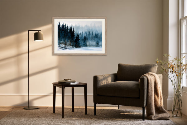 Framed snowy forest artwork above an armchair, side table, and black floor lamp.