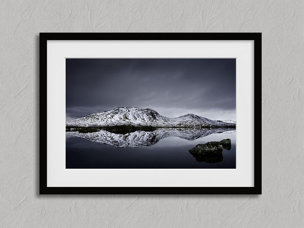 Silent Mirror shown in a black frame with a white border or mount.