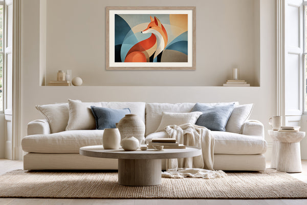 Light wood-framed geometric fox artwork displayed above a white sofa with blue accent cushions.