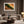 A framed landscape art print featuring a green and orange canyon scene