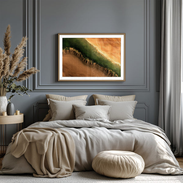 A framed landscape art print featuring a green and orange canyon scene