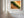 A framed landscape art print featuring a green and orange canyon scene