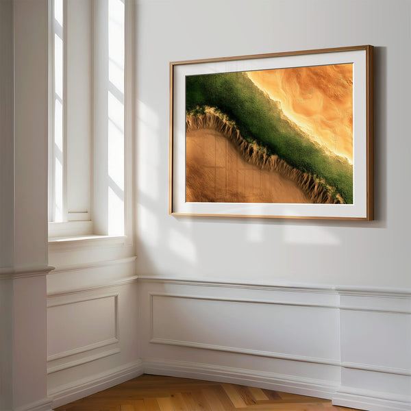 A framed landscape art print featuring a green and orange canyon scene