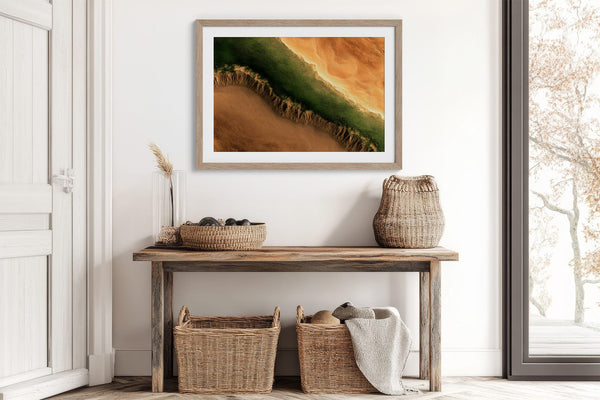 A framed landscape art print featuring a green and orange canyon scene