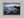 Ethereal Dawn coastal wall art featuring Northumbrian castle ruins, rocky shoreline and calm sea at sunrise