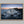 Ethereal Dawn coastal wall art featuring Northumbrian castle ruins, rocky shoreline and calm sea at sunrise