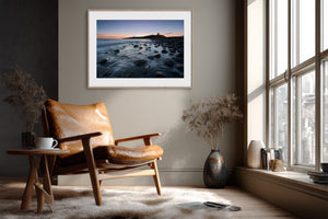 Ethereal Dawn coastal wall art featuring Northumbrian castle ruins, rocky shoreline and calm sea at sunrise