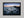 Ethereal Dawn coastal wall art featuring Northumbrian castle ruins, rocky shoreline and calm sea at sunrise
